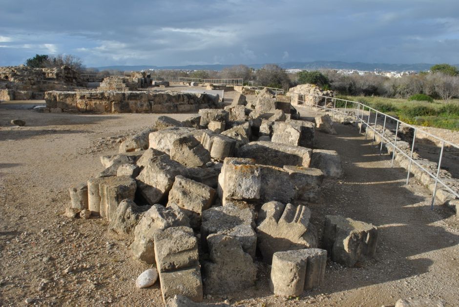 Scenic view of ancient ruins with fragmented stone columns and overcast skies