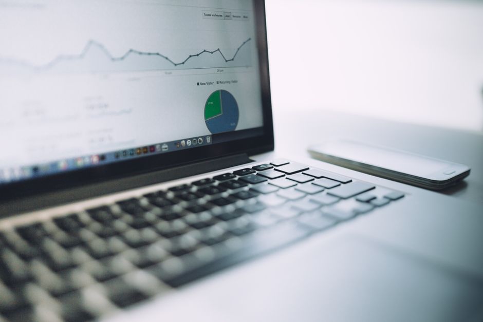 A laptop showing an analytics dashboard with charts and graphs, symbolizing modern data analysis tools