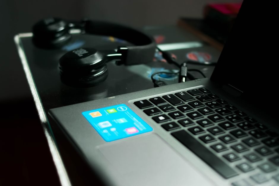 A close-up view of a laptop and headphones on a desk, perfect for tech and work themes