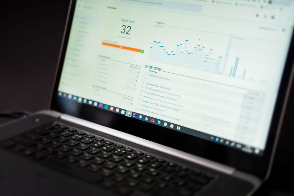 A laptop displaying an analytics dashboard with real-time data tracking and analysis tools